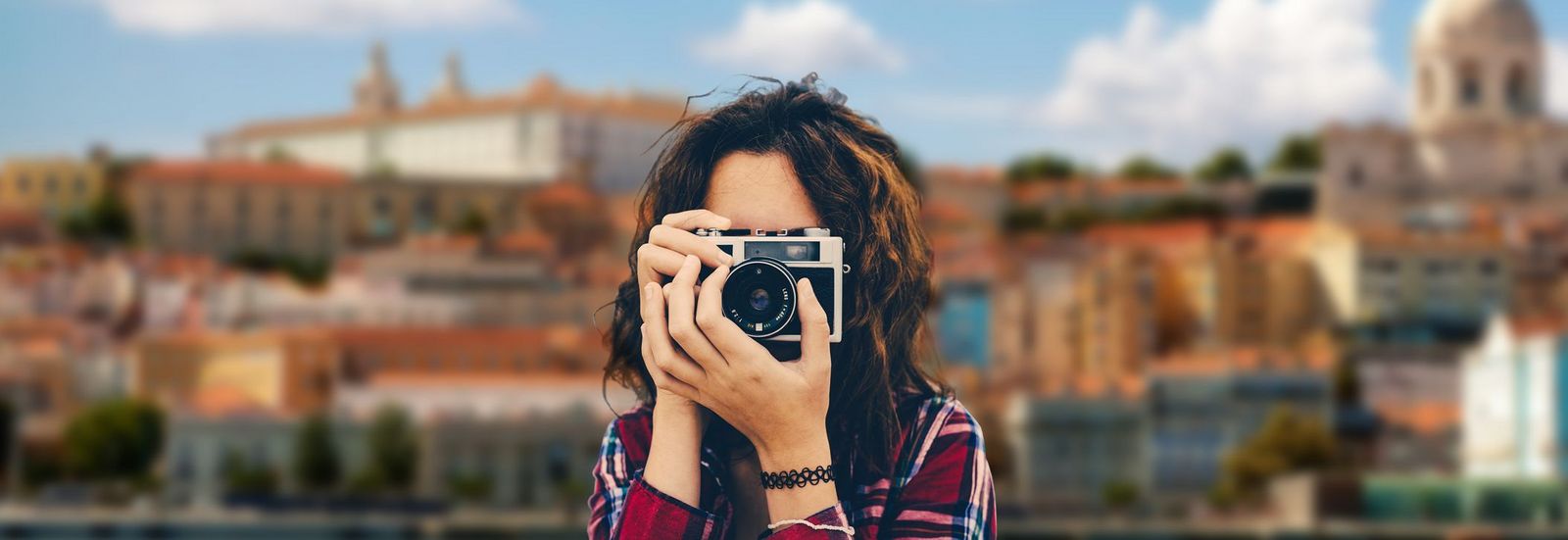 Reiseblog Frau macht Foto vor Stadtkulisse