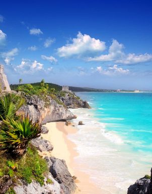 weisser Sandstrand mit tuerkisfarbigem Meerwasser in Mexiko